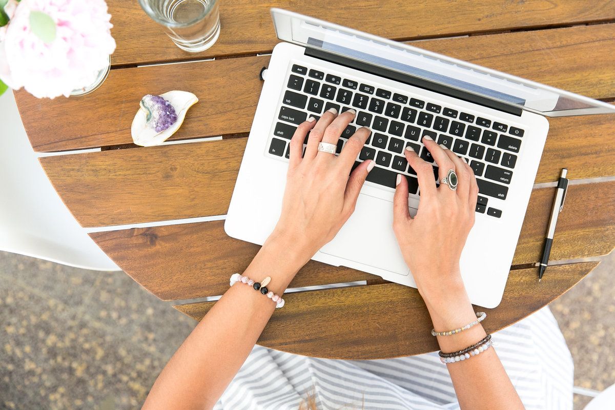 Working on a laptop at a wooden table