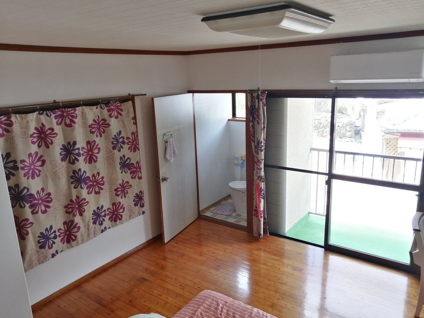 Living room with wooden floor and balcony access